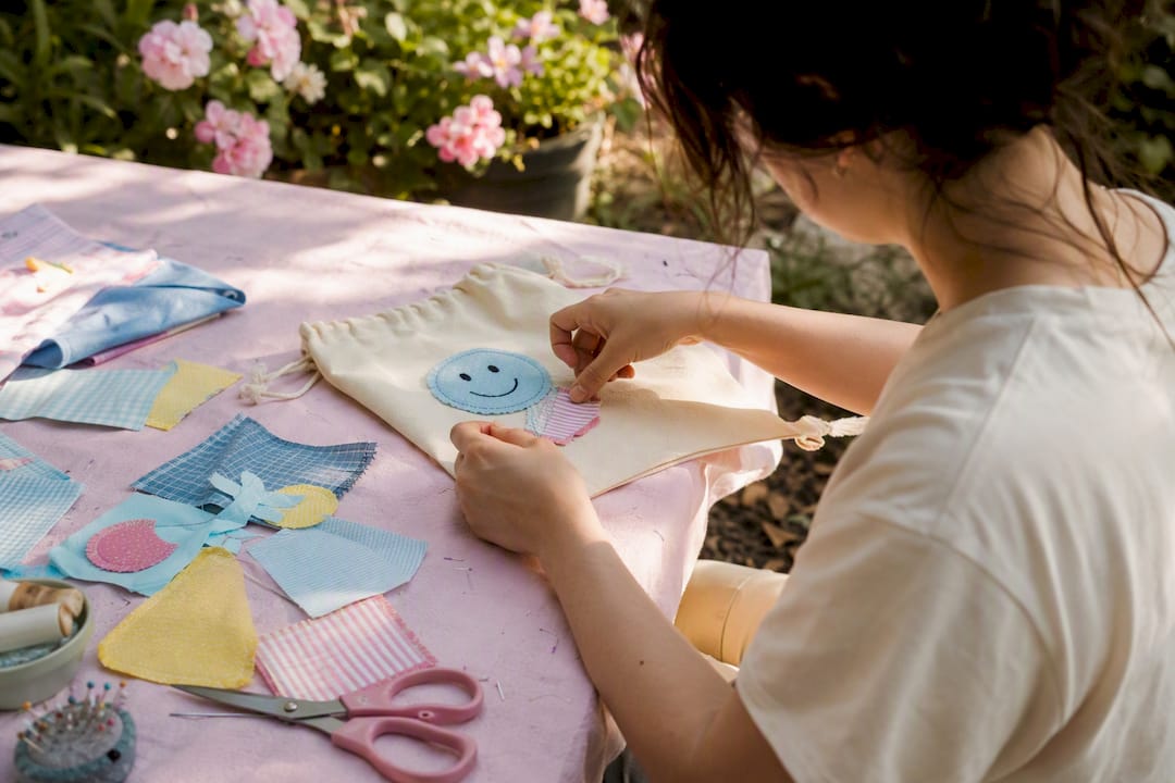 Hands assembling personalized loot bag with patches