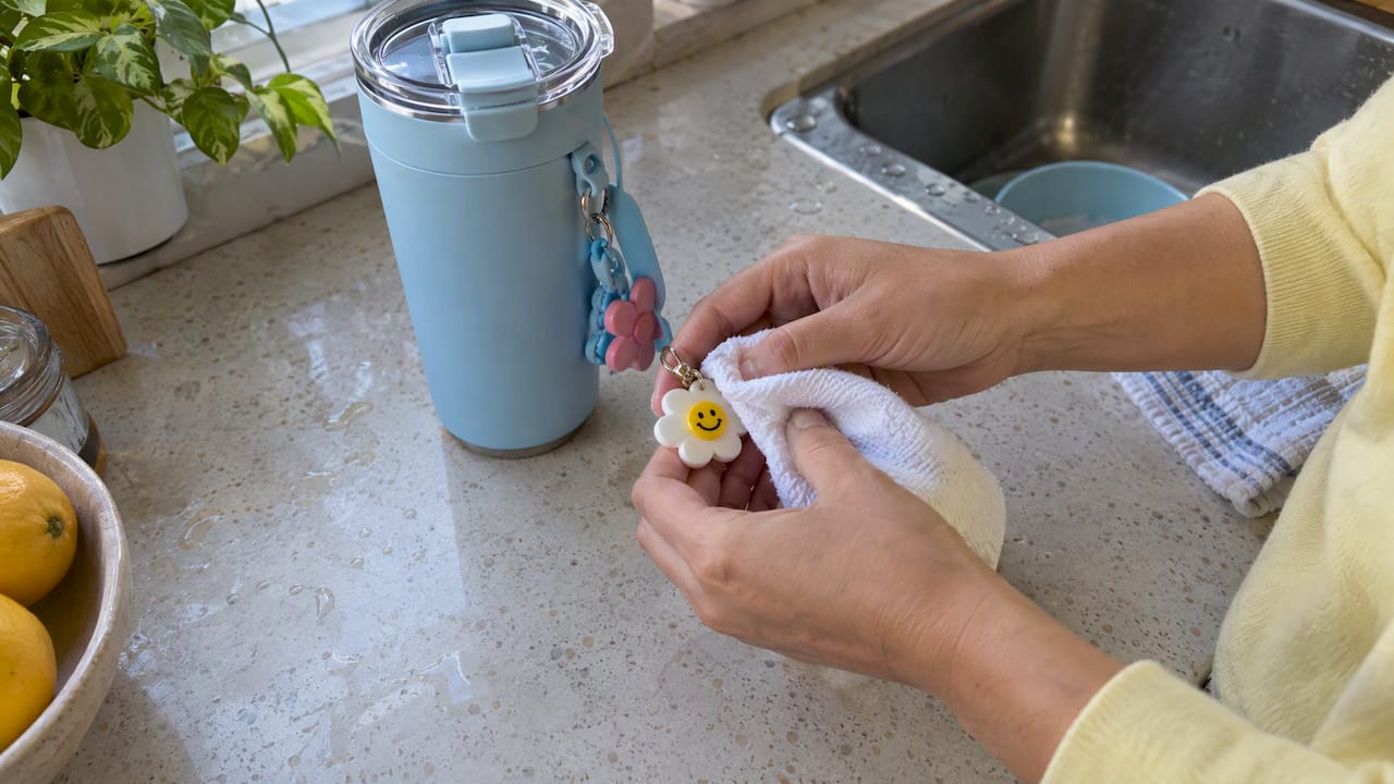 Removable tumbler charm wiped with a damp cloth